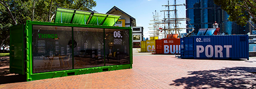 Containers in situ outside Wharf 7 with the museum building in the background